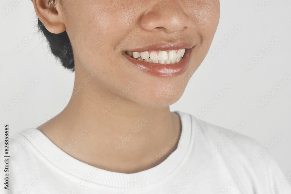 Close up of a woman toothy smile on white background. Close up of a woman toothy smile on white background.