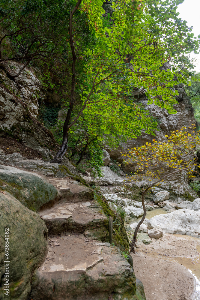 A walking trail following the river bed leading to a waterfall. Nydri waterfall. Lefkada. Greece. A walking trail following the river bed leading to a waterfall. Nydri waterfall. Lefkada. Greece.