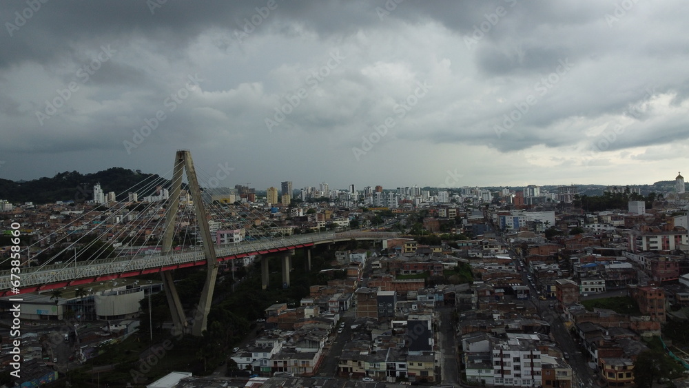 Pereira's iconic bridge stands as a testament to urban growth against a backdrop of city life.