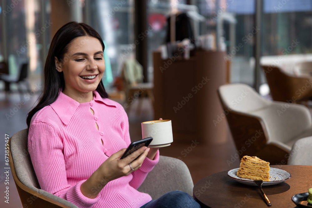 A girl in a pink shirt sitting in a cafe and feeling positive A girl in a pink shirt sitting in a cafe and feeling positive