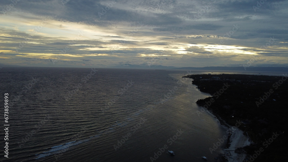Bohol's skies are painted with the vibrant hues of sunset, perfect for a tranquil vacation evening. Bohol's skies are painted with the vibrant hues of sunset, perfect for a tranquil vacation evening.