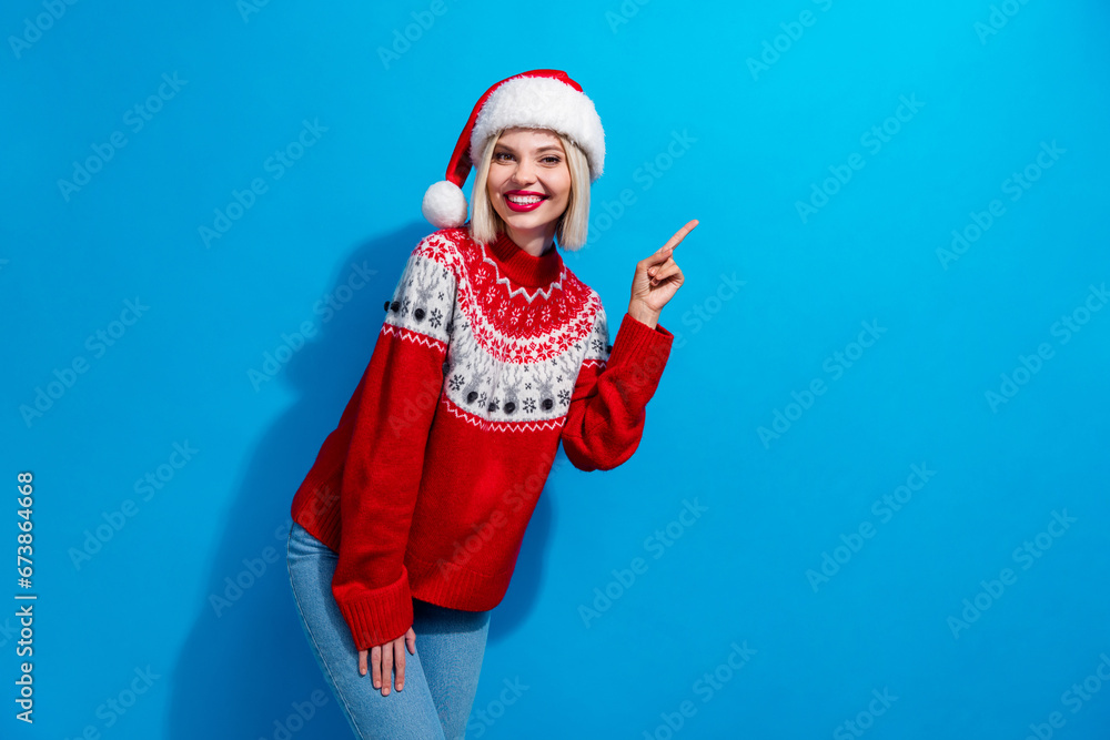 Obraz premium Photo of adorable sweet woman lady santa elf wear ornament pullover pointing empty space isolated blue color background