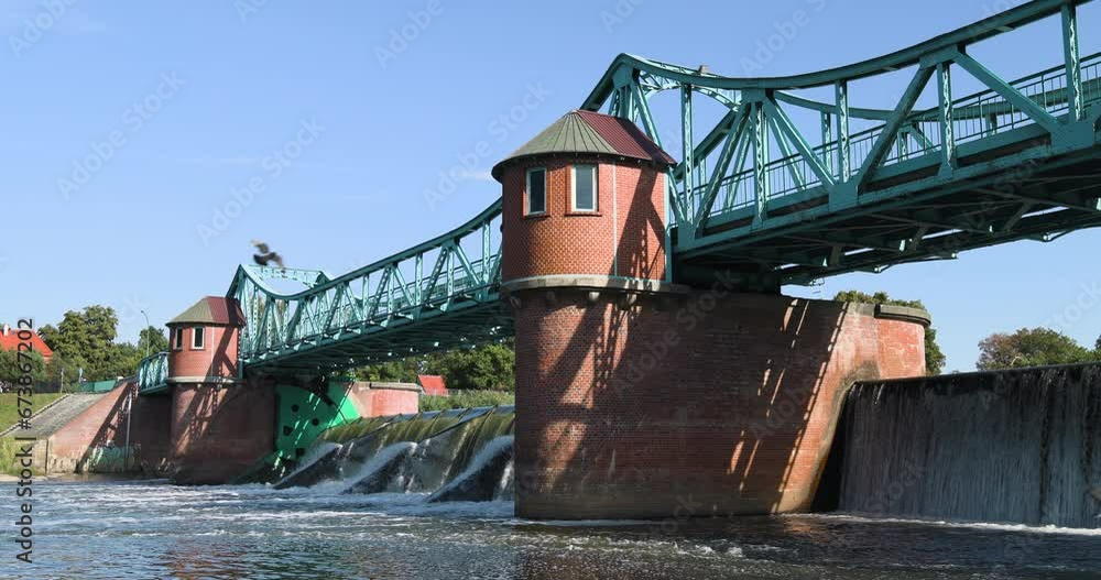  Water flowing over a dam on a river, a bridge over a dam, the sound of flowing water, flying birds