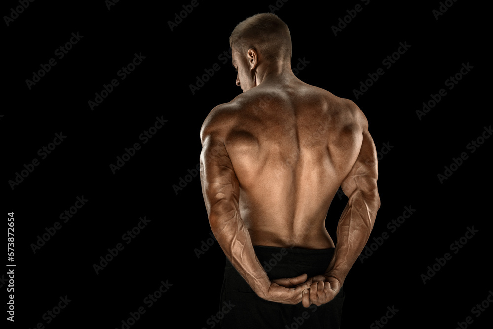 Handsome power bodybuilder showing his back