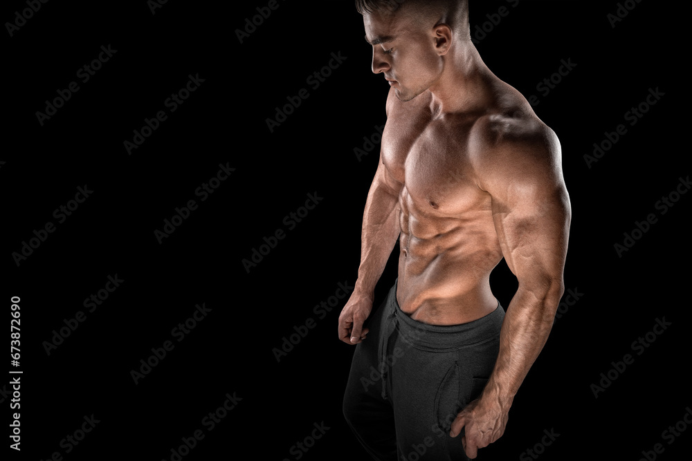 Fototapeta premium Young bodybuilder side view looking down