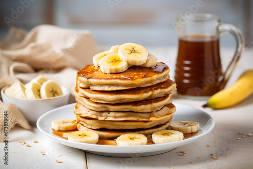 Stack of banana pancakes with honey syrup on plate