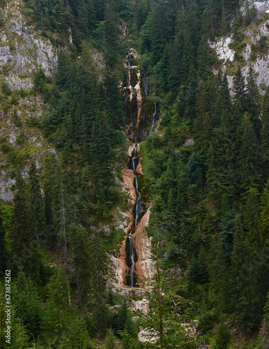 Vertical shot of the Cascada Cailor surrounded by greenery in Romania photo