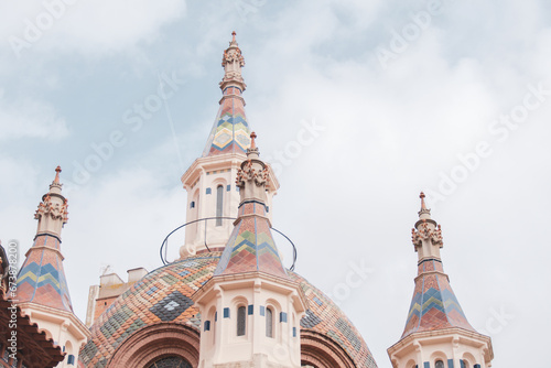 Dome and towers of Saint Roma's Church at Lloret de Mar in Girona Province. Saint Roma is a small gothic cathedral built by a lot of colorful tiles and it's representative of Catalan modernism. photo