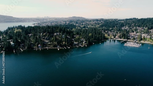 Aerial video of the sea with trees and buildings on the shore photo