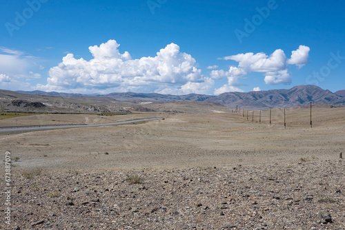 Infrastructure in the steppe on a bright sunny day. Roads and electricity supply in the steppe.