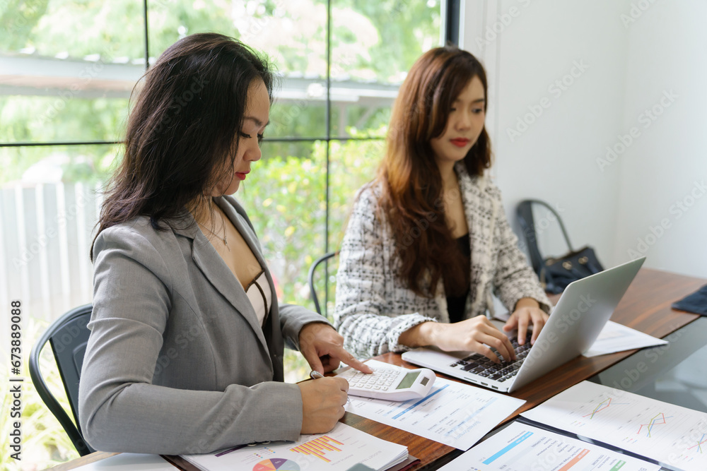 Businesswoman Accountant analyzing investment charts Invoice and pressing calculator buttons over documents. Accounting Bookkeeper Clerk Bank Advisor And Auditor Businesswoman Accountant analyzing investment charts Invoice and pressing calculator buttons over documents. Accounting Bookkeeper Clerk Bank Advisor And Auditor