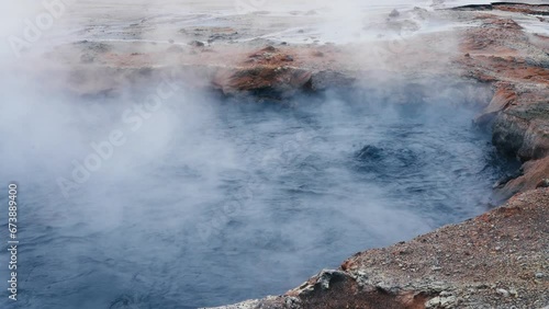 Bubbling gray mud puddles in Hverir, Iceland. Geothermal area, strong sulfur smell. Toxic gases and unstable ground. Heat causes the water to evaporate and mix with mud.