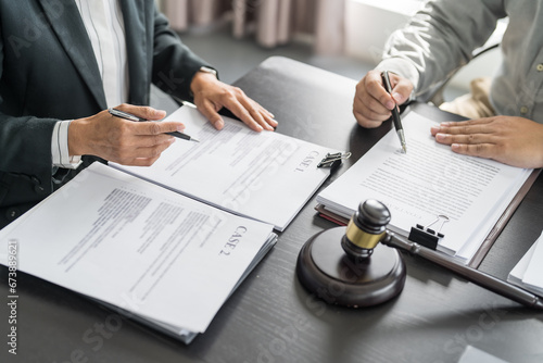 Lawyer Legal counsel presents to the client a signed contract with gavel and legal law. justice and lawyer Business partnership meeting concept photo