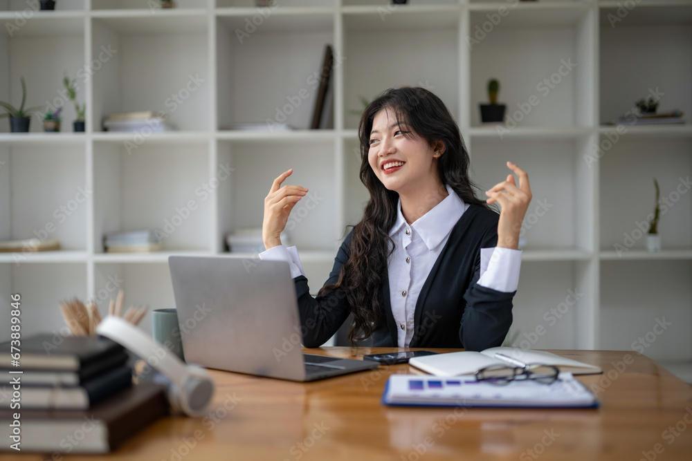 Freelance Asian woman enjoying video call on her laptop Remote work and communications. Freelance Asian woman enjoying video call on her laptop Remote work and communications.