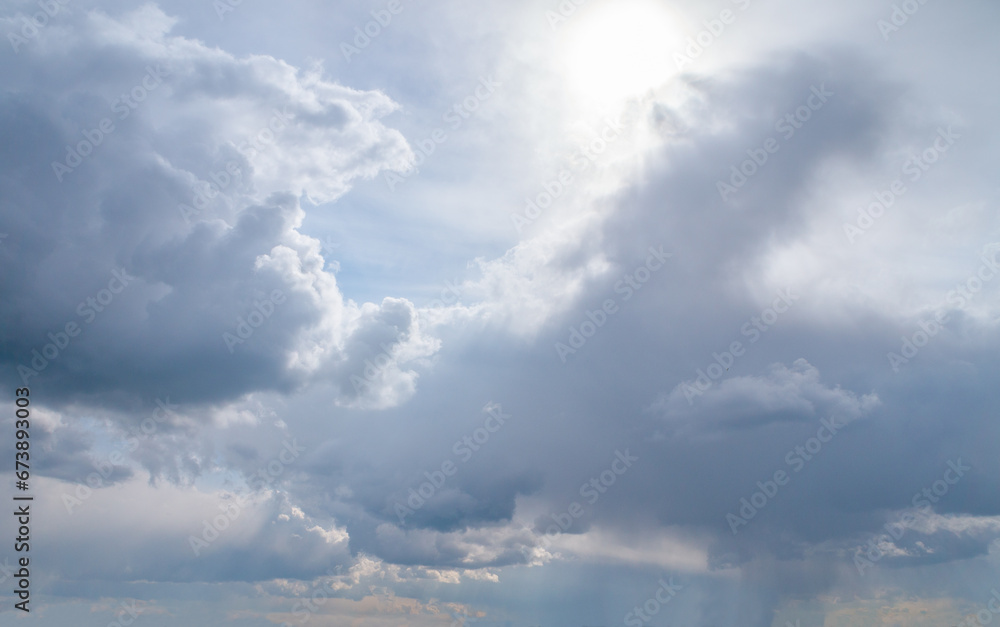 Obraz premium White fluffy clouds, sun and blue sky. Majestic view in summer.