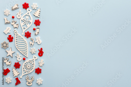 White and red Christmas toys on a blue background, Merry Christmas and Happy New Year concept, top view, copy space © pundapanda