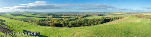 Wide panorama from Burton Dassett Hills on a bright autumnal day with far reaching views over Warwickshire, England