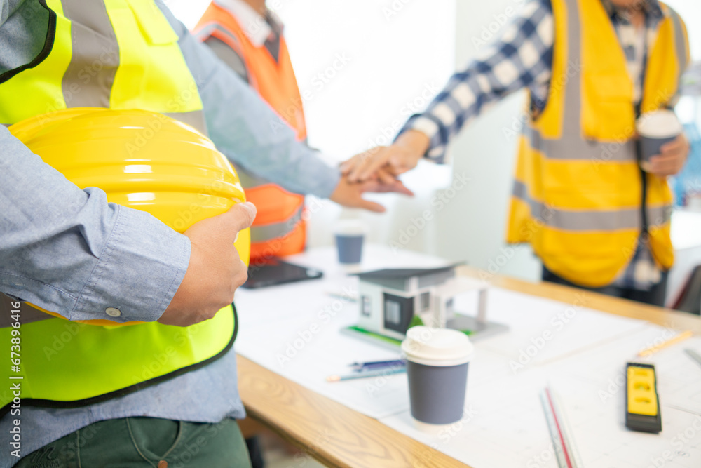 Architects and construction engineering handshake after meeting discuss structural blueprints calculate project completion. cooperation and handshake between of construction engineers and architects. Architects and construction engineering handshake after meeting discuss structural blueprints calculate project completion. cooperation and handshake between of construction engineers and architects.