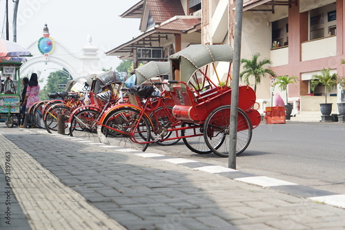 A simple means of transportation (becak) is parked in the Malioboro area of ​​Yogyakarta.
