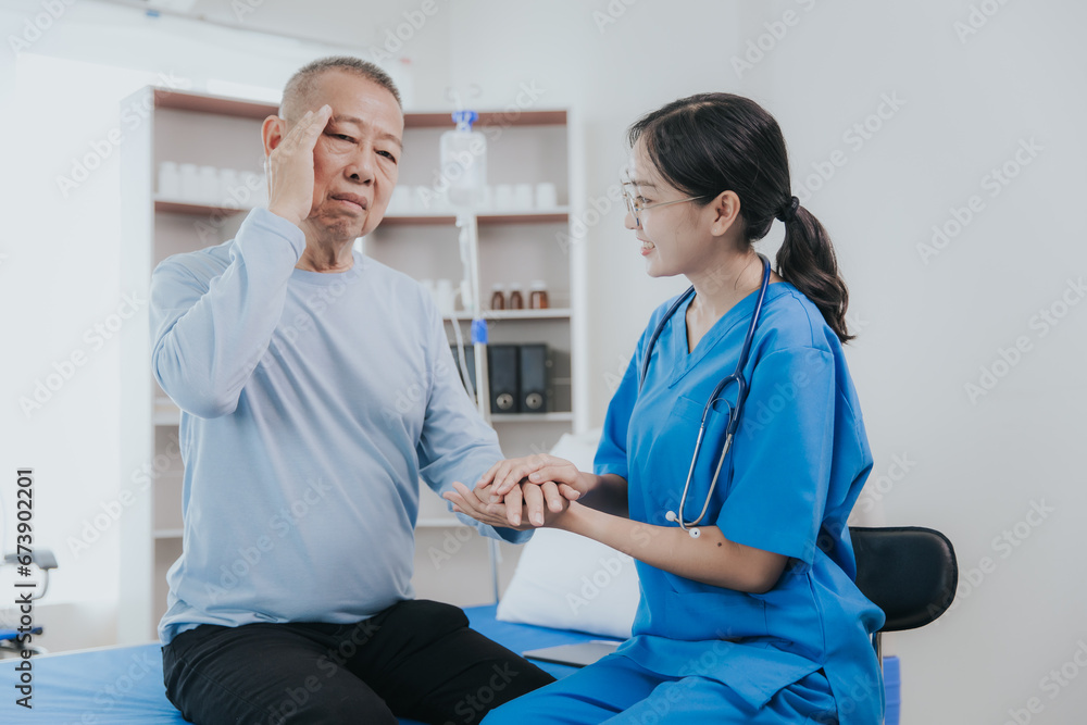 Obraz premium Beautiful Asian female nurse in a nursing uniform talks to a senior patient at the bedside in a hospital or clinic department.