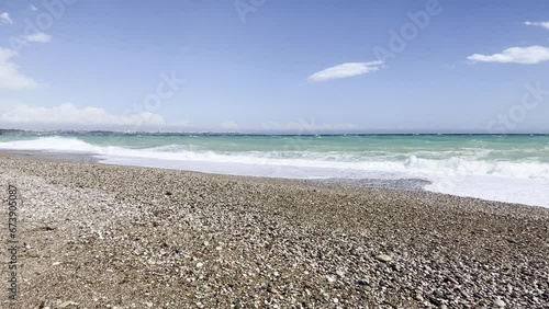 Storm at sea. sea waves are crashing on coast. Waves splash on the beach with pebbles during a storm. 