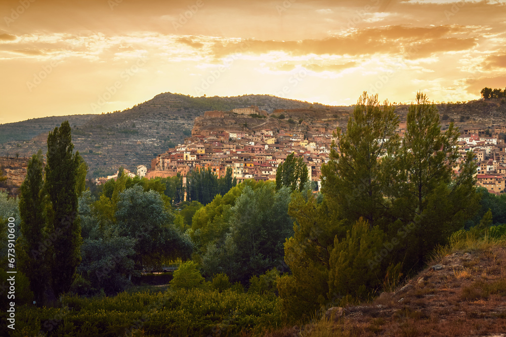 View of the village of Ademuz in Spain illuminated by a reddish sunset sky