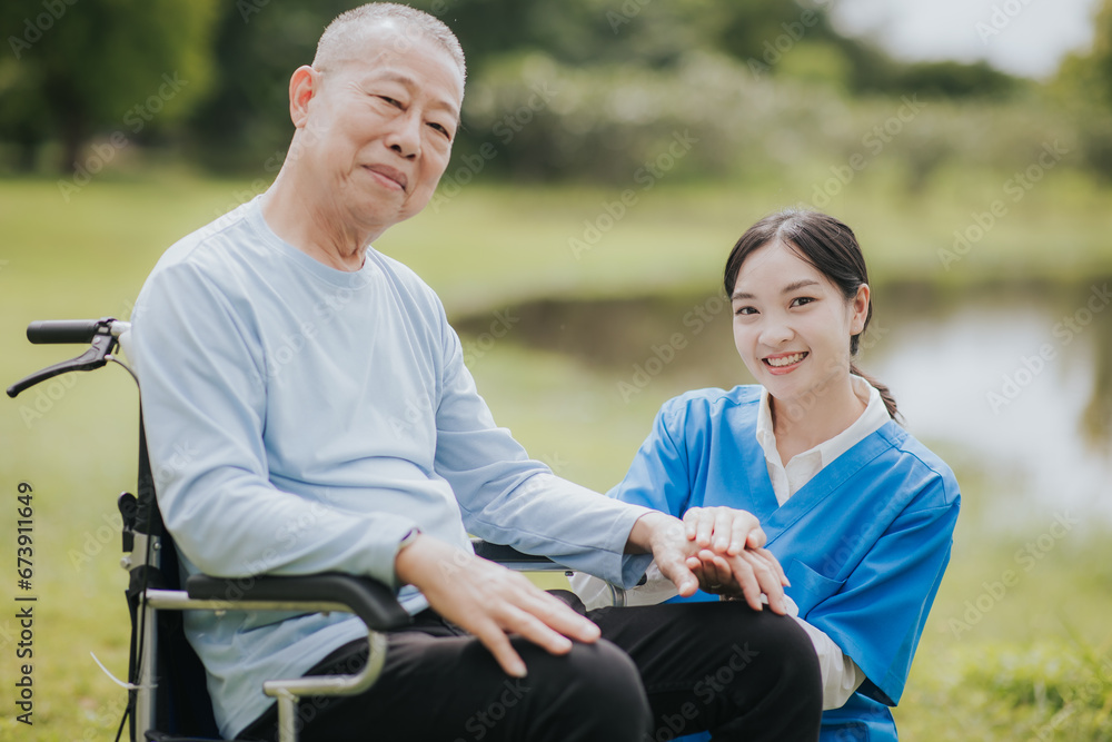 Happy young nurse talks to an elderly man with a disability Happy young nurse talks to an elderly man with a disability