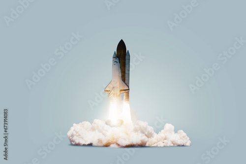 Fototapeta Naklejka Na Ścianę i Meble -  Creative shuttle rocket takes off successfully with blast and clouds of smoke on a blue background, concept. Spaceship launches, creative idea. Start up.