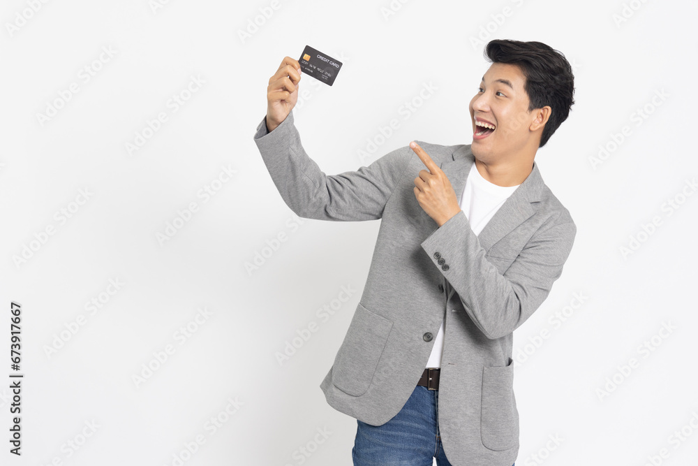 Young Asian businessman showing credit card isolated on white background Young Asian businessman showing credit card isolated on white background