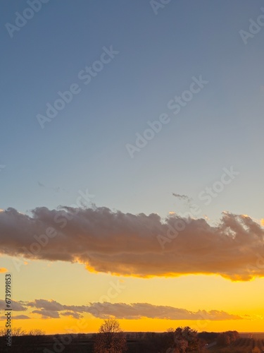 Fototapeta Naklejka Na Ścianę i Meble -  A sunset with clouds and blue sky