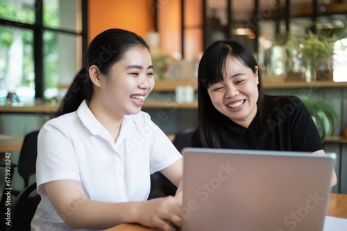 Happy Asian women co-workers in workplace including person with blindness disability using laptop with screen reader program for visual impairment people. Disability inclusion, Generative AI