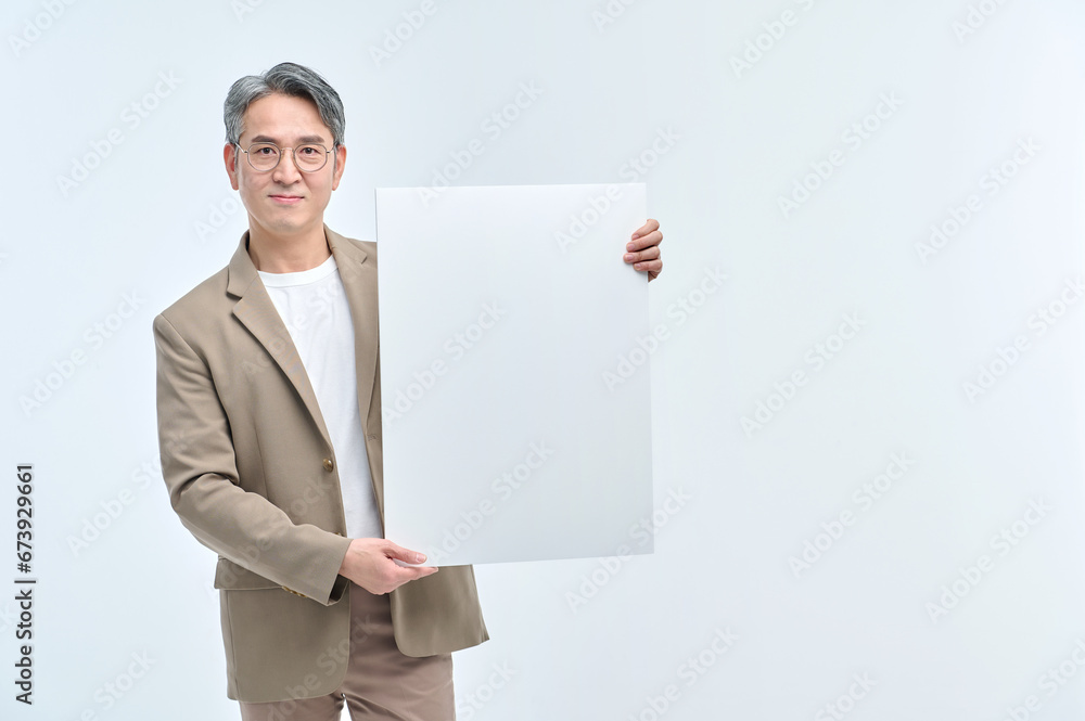 A middle-aged man in a suit and glasses is holding a white sign and making various facial expressions and gestures. A middle-aged man in a suit and glasses is holding a white sign and making various facial expressions and gestures.