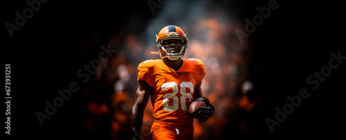 dynamic banner portrait of American football sportsman player in orange uniform on black background with smoke photo