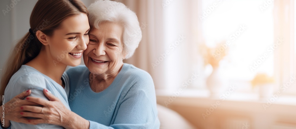 Nurse hugging elderly patients during visit at home Nurse hugging elderly patients during visit at home