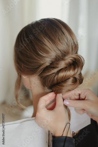 bridal bun hairstyle of brunette bride at the getting ready	 photo