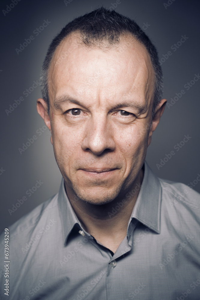 Studio shot portrait man 50s pensive expression Studio shot portrait man 50s pensive expression