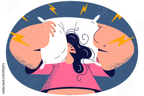 Stressed woman cover ears with pillow