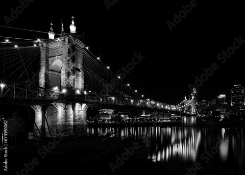 Grayscale shot of the John A. Roebling Suspension Bridge in Covington, Kentucky. photo