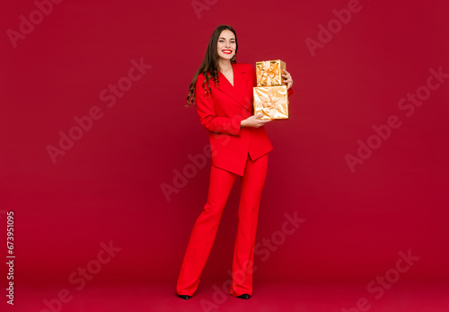 attractive woman celebrating Christmas on red background © mary_markevich