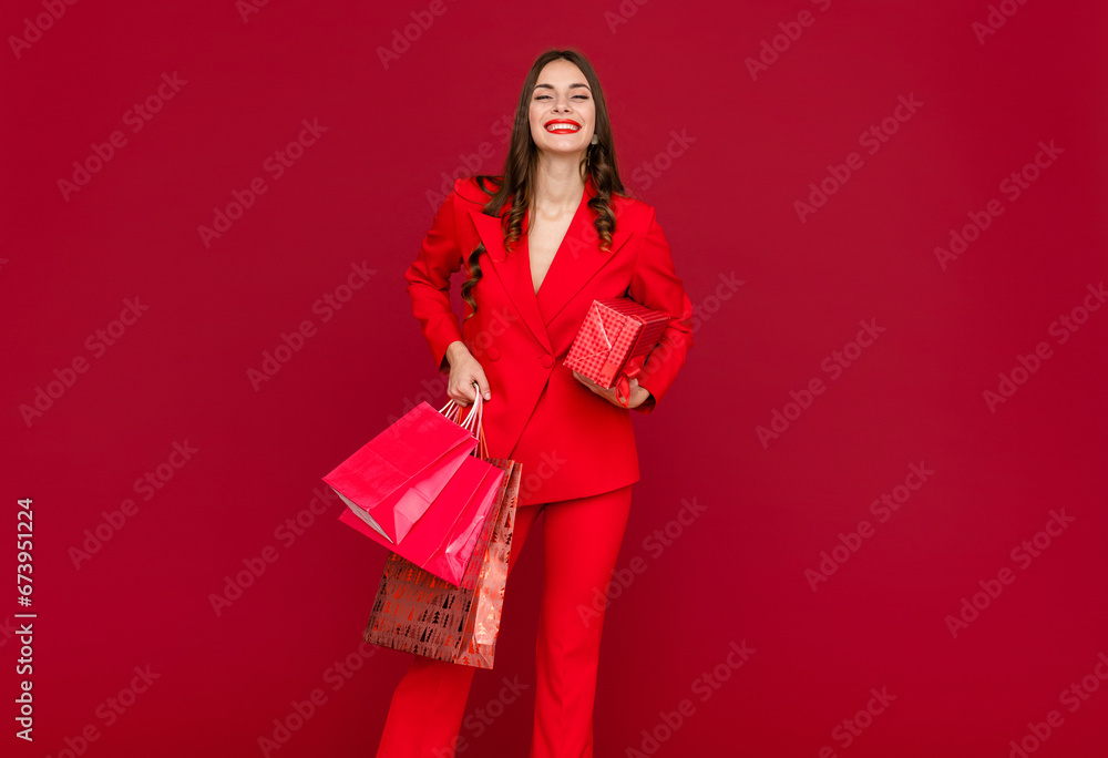 attractive woman in red with shopping bags sale on red background attractive woman in red with shopping bags sale on red background