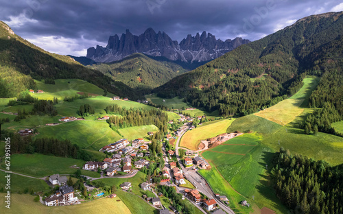 Stunning Alpine scenery of breathtaking Dolomites rocks mountains in Italian Alps, South Tyrol, Italy. Aerial view of Val di Funes and village Santa Maddalena, Valley Isarco