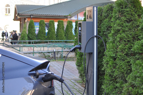 Electric car charging station with blue sky and clouds background. EV car concept. electric vehicle, environmentally friendly, future technology and clean energy, alternative energy.