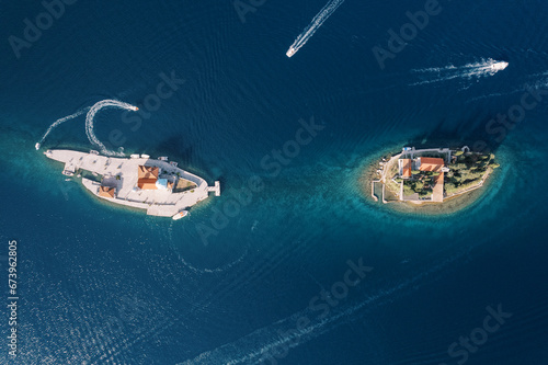 Boats sail around the islands of Gospa od Skrpjela and St. George. Montenegro. Drone photo