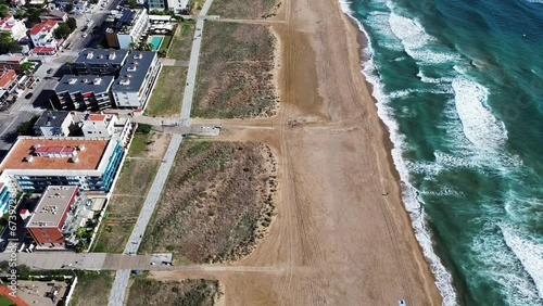aerial beach view drone shot with sand and waves 