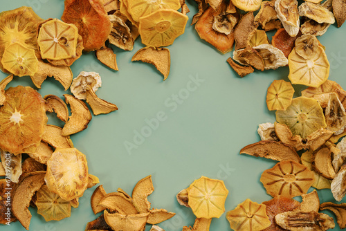 Ornament of thin fruit chips on a light green background