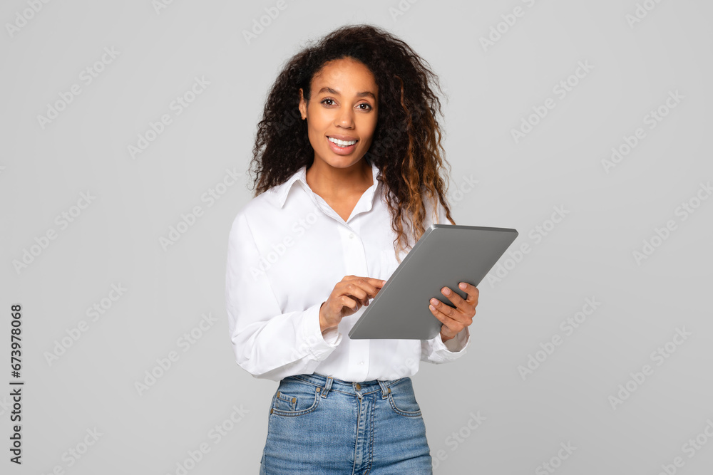African American lady using her tablet computer for business, studio African American lady using her tablet computer for business, studio