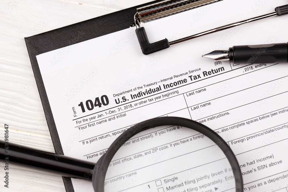 Form 1040 US Individual Income Tax Return on A4 tablet lies on office ...