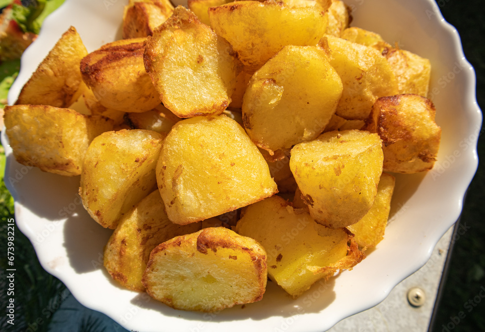 Potatoes fried in a frying pan close-up, lying on a white plate, Horizontal view from above, food background Potatoes fried in a frying pan close-up, lying on a white plate, Horizontal view from above, food background