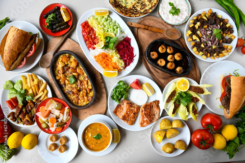 Table scene of assorted take out or delivery foods. Traditional Turkish cuisine. Various Turkish meal and appetizers. Top down view on a table. photo