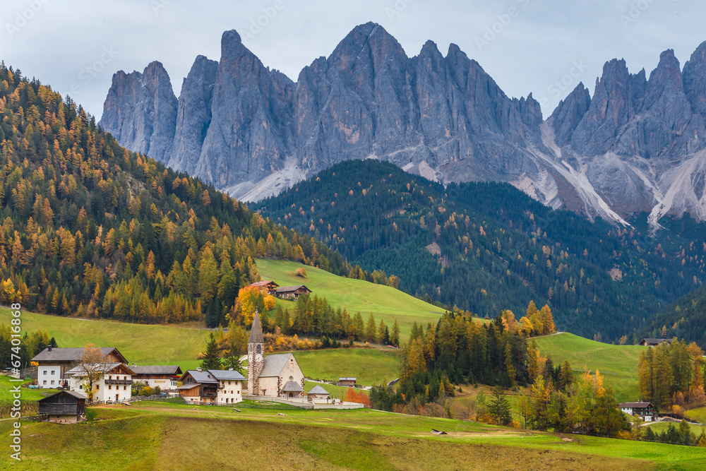 Famous place Santa Maddalena village with Dolomites mountains in background, Val di Funes valley